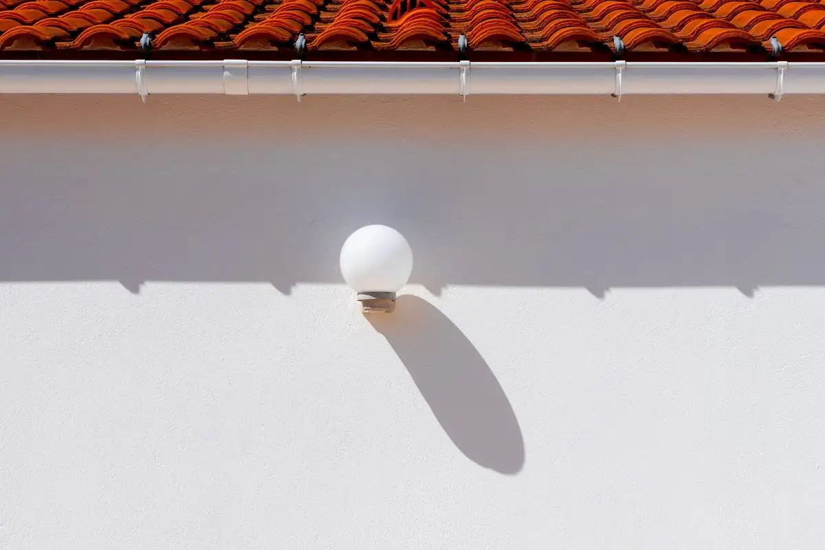 White gutter under a terracotta tile roof edge