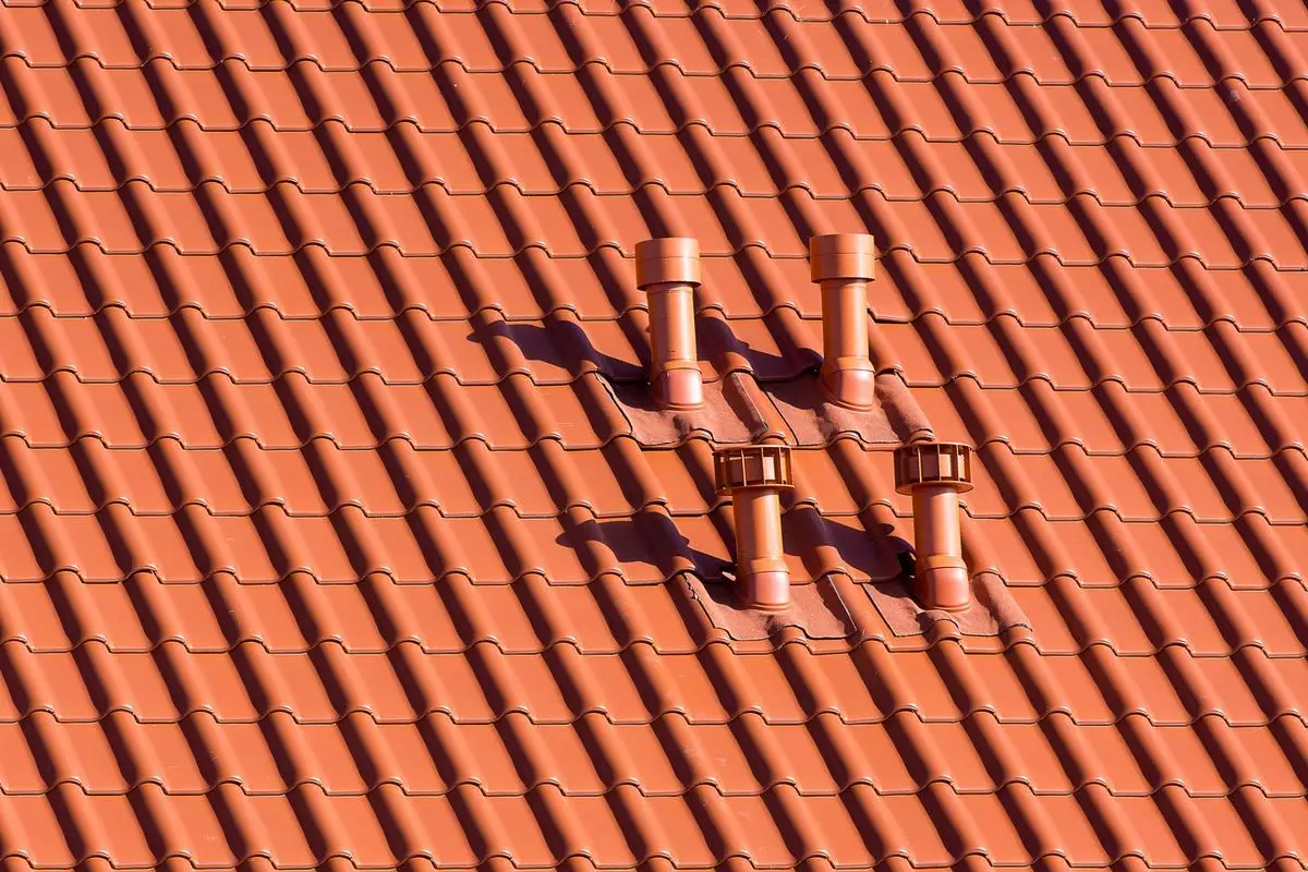Red tile roof with vent pipes along the slope